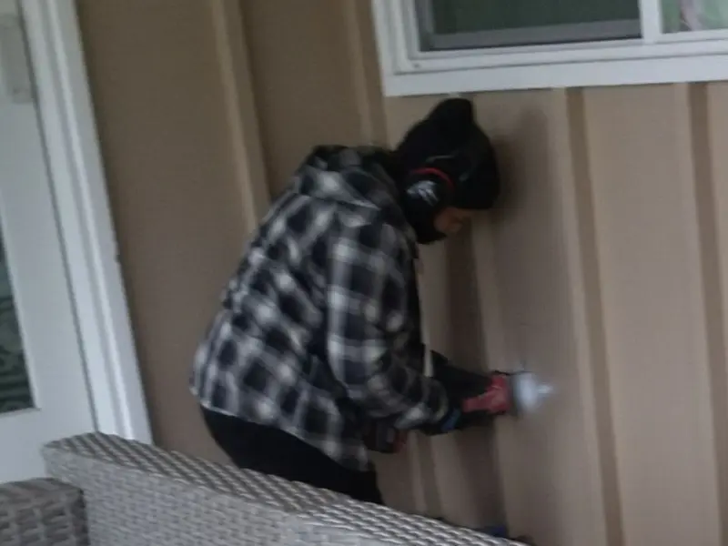 Professional electrician installing an exterior outlet in Mansfield